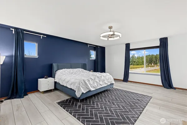 a bedroom with a large bed and a window