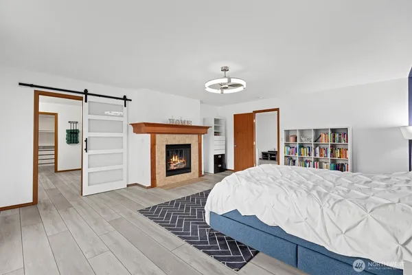 a bedroom with a bed and a fireplace