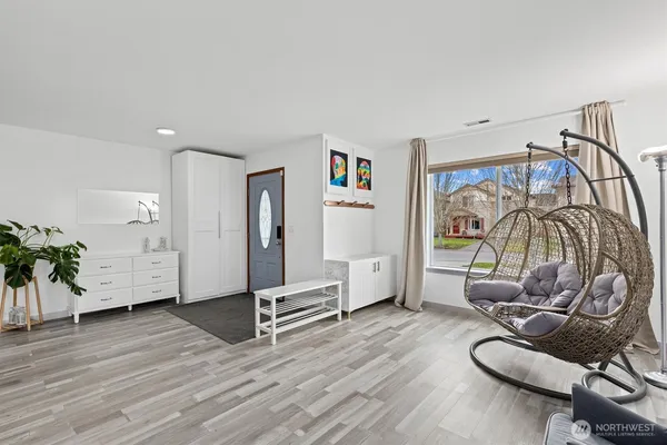 a bedroom with furniture and a wooden floor