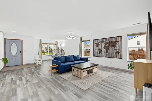 a living room with furniture and wooden floor