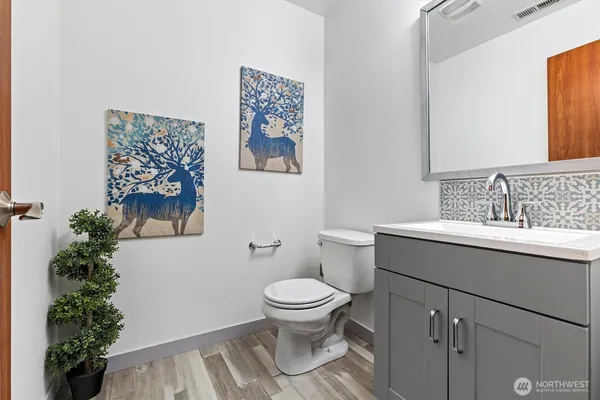 a bathroom with a sink toilet and a mirror