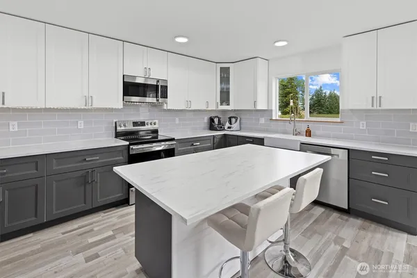 a kitchen with a sink stove and microwave