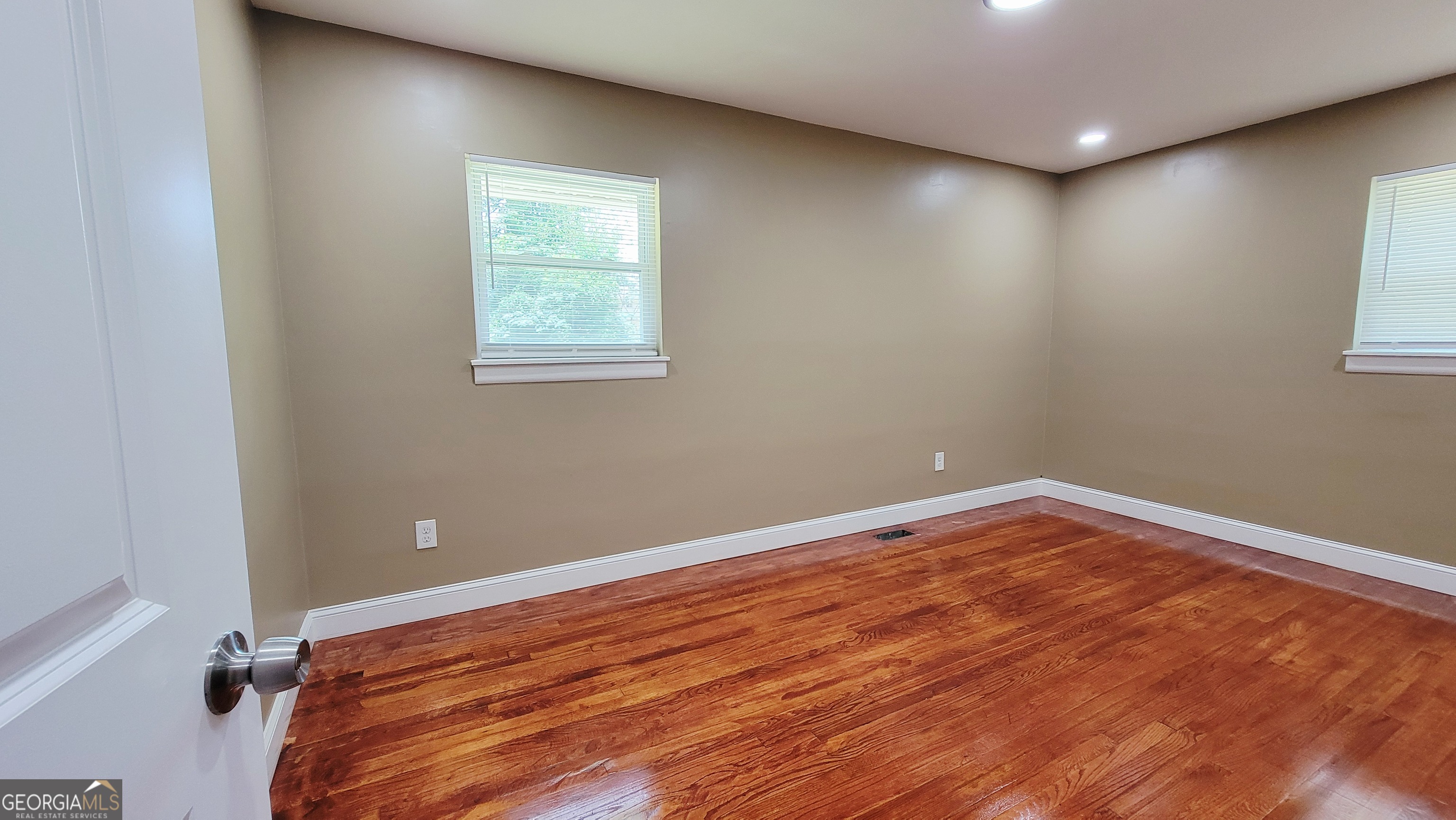 4491 Glade Road Forest Park, GA 30297 - Photo 17 of 41 an empty room with wooden floor and windows