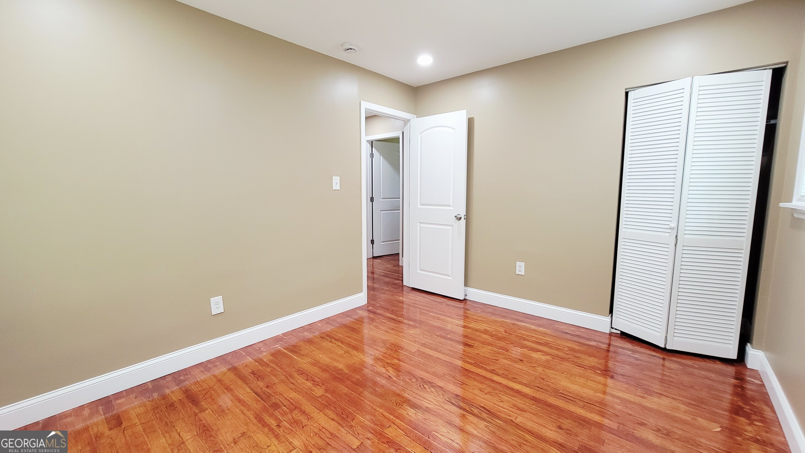 4491 Glade Road Forest Park, GA 30297 - Photo 20 of 41 a view of an empty room with wooden floor and closet