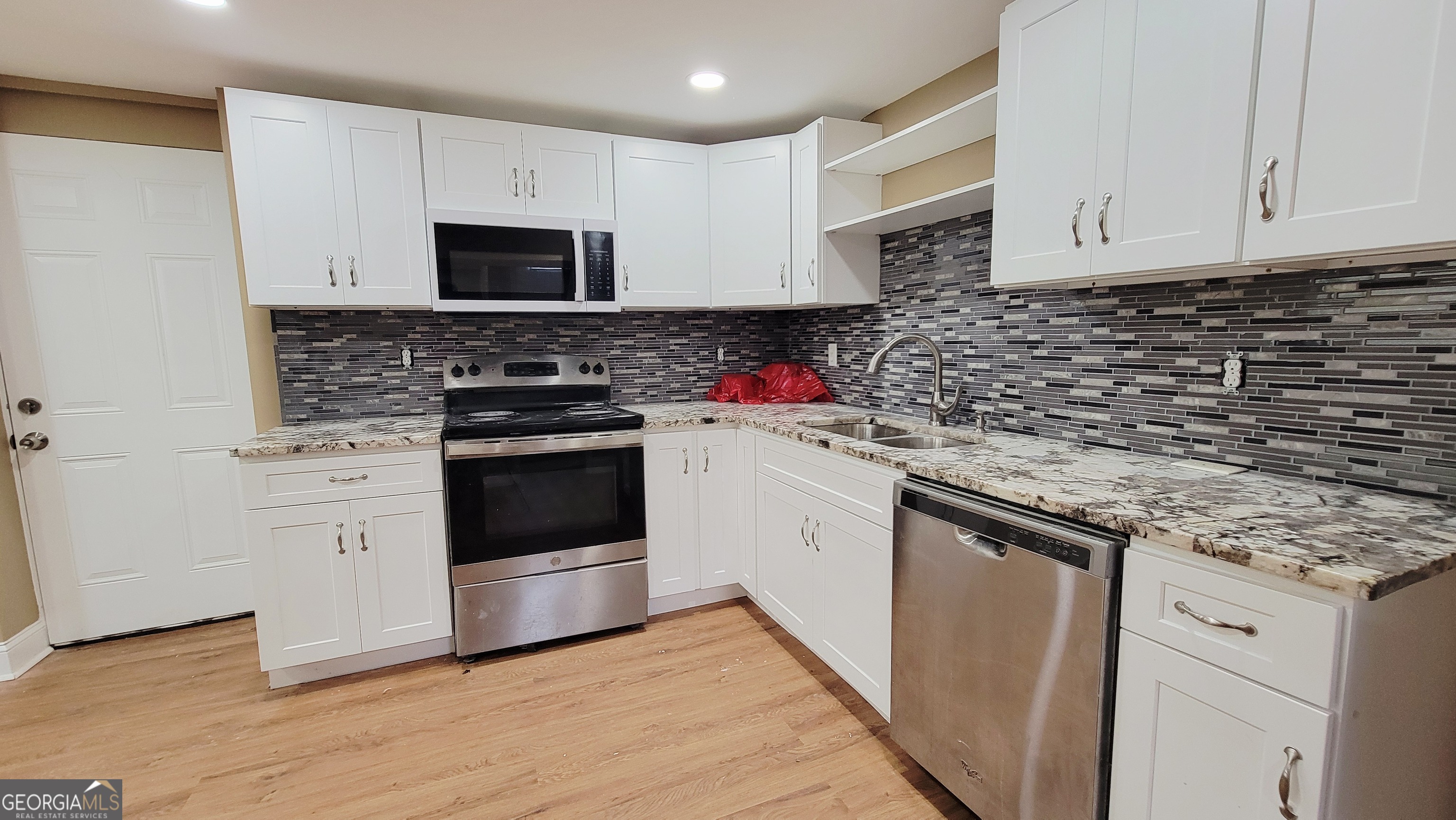 4491 Glade Road Forest Park, GA 30297 - Photo 25 of 41 a kitchen with cabinets stainless steel appliances and a sink