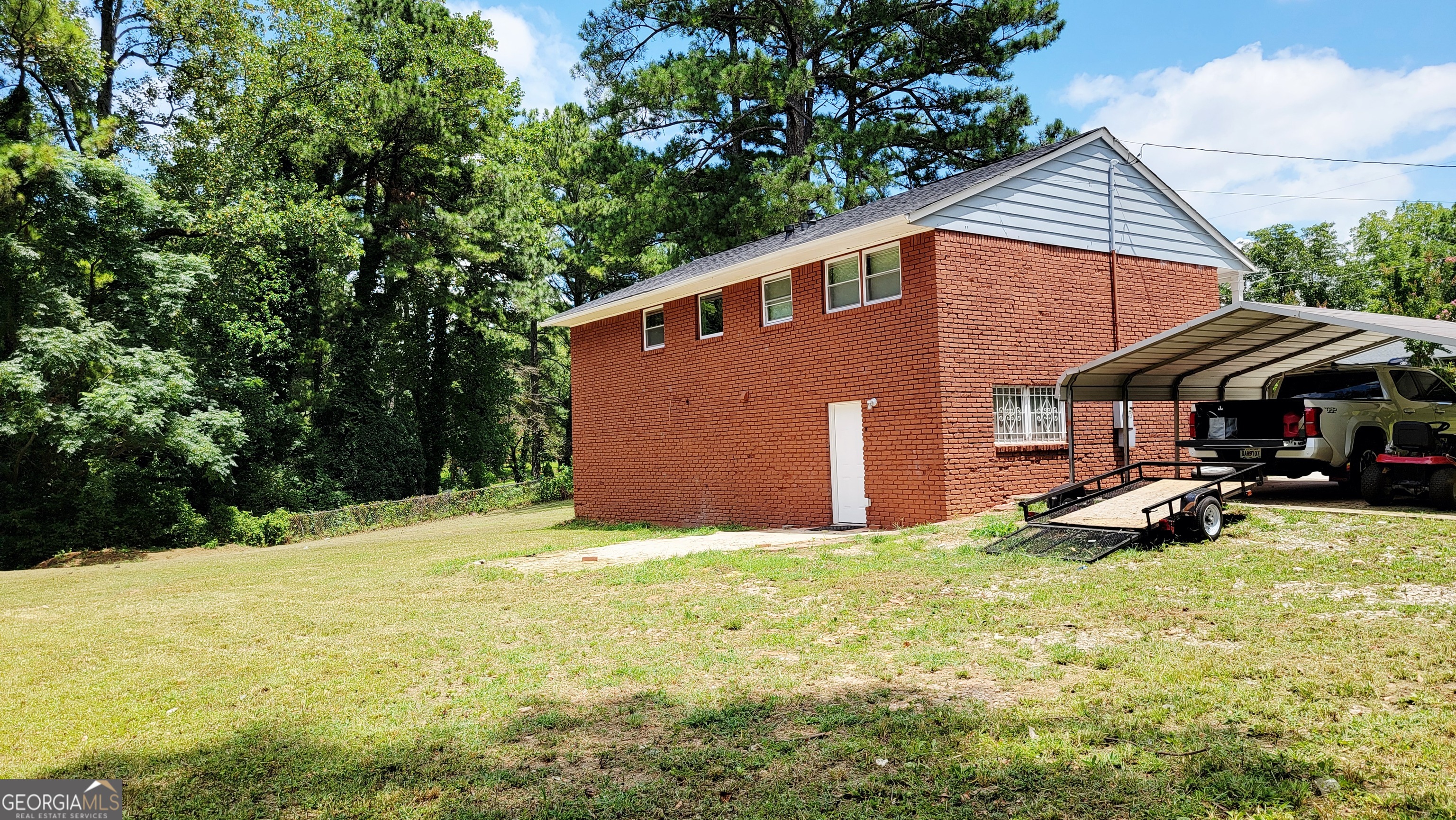 4491 Glade Road Forest Park, GA 30297 - Photo 40 of 41 a view of a house with backyard and sitting area