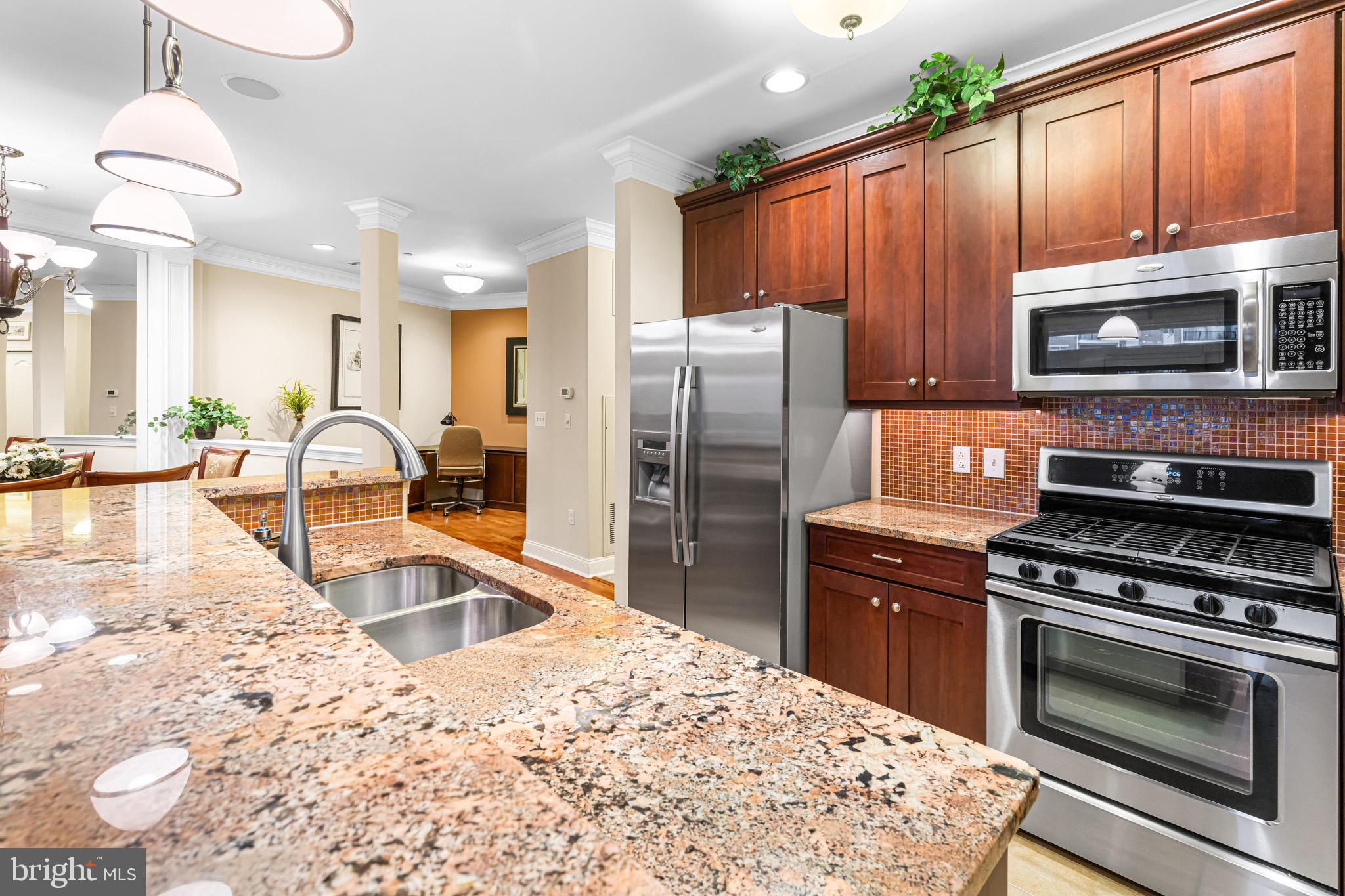 227 Carson Terrace Huntingdon Valley, PA 19006 - Photo 12 of 32 a kitchen with wooden cabinets and stainless steel appliances