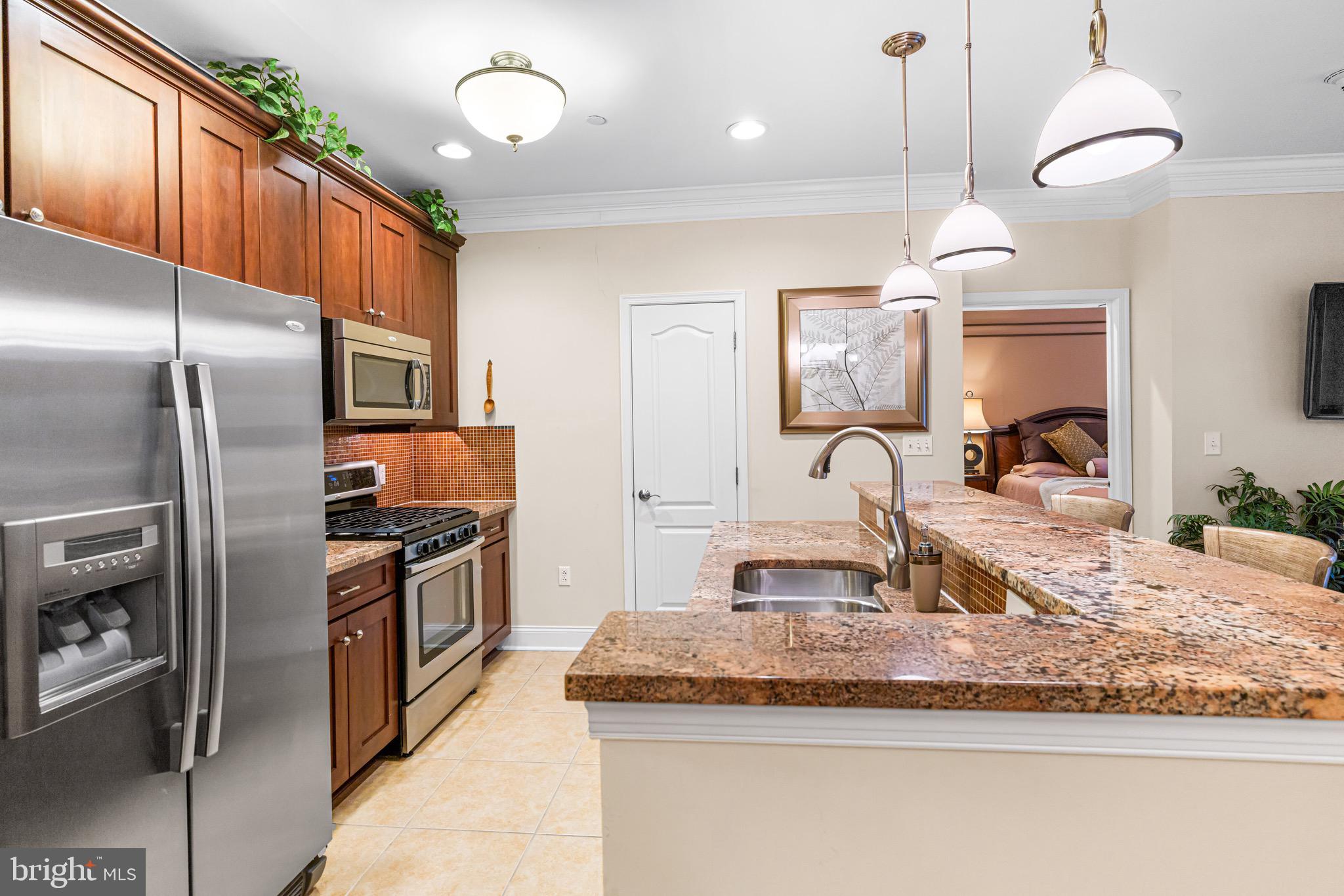 227 Carson Terrace Huntingdon Valley, PA 19006 - Photo 13 of 32 a kitchen with stainless steel appliances granite countertop a sink refrigerator and microwave