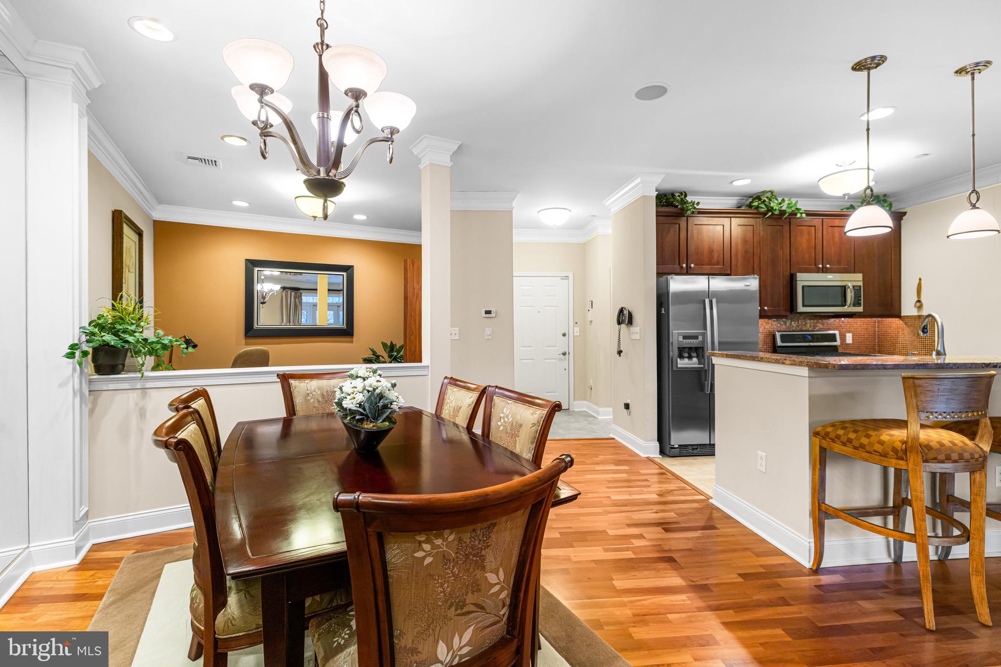 227 Carson Terrace Huntingdon Valley, PA 19006 - Photo 8 of 32 a dining room with furniture a chandelier and wooden floor