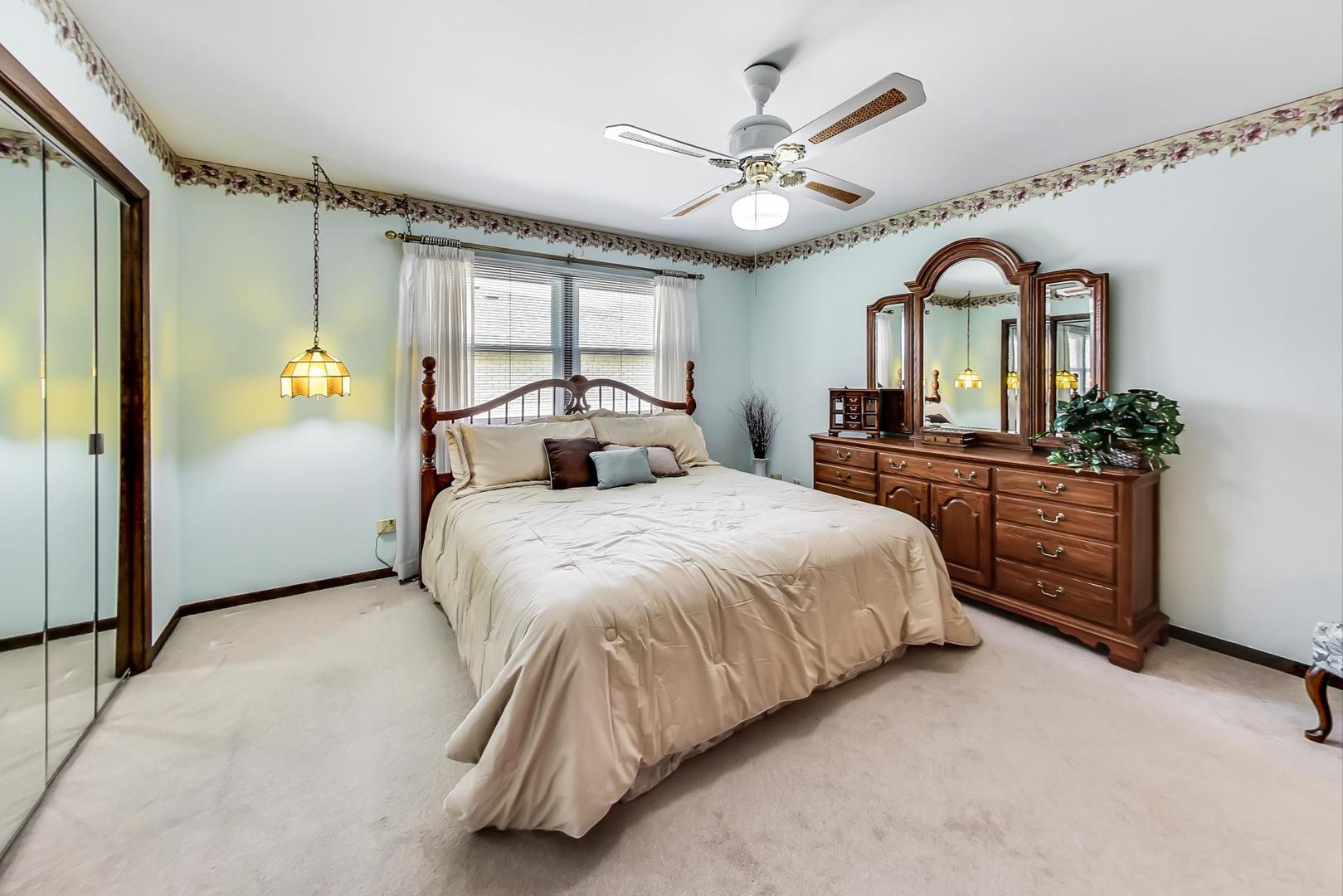 306 North Marcella Road Mount Prospect, IL 60056 - Photo 19 of 31 a bed room with a bed mirror and a large window
