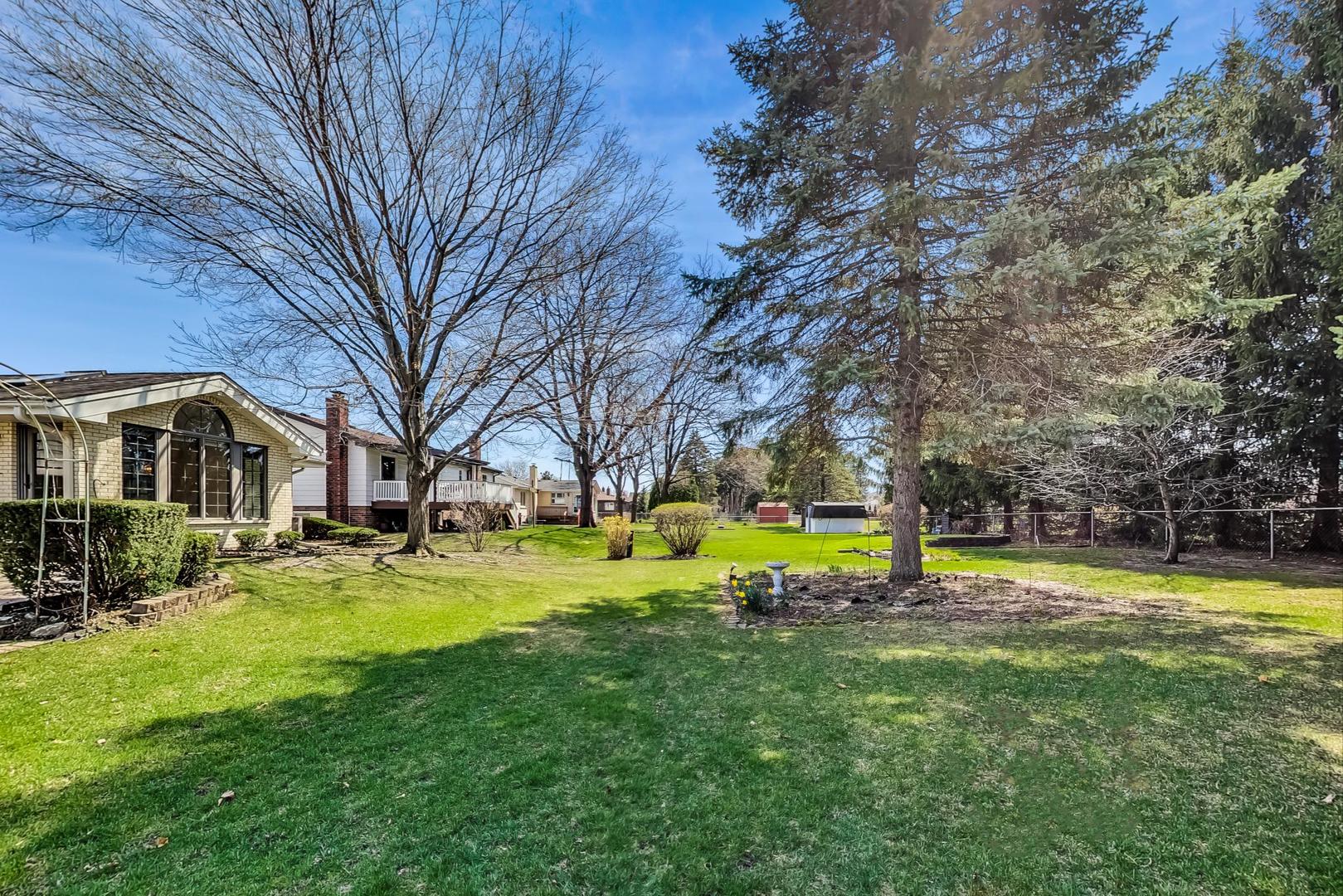 306 North Marcella Road Mount Prospect, IL 60056 - Photo 26 of 31 a view of a house with a big yard and large trees
