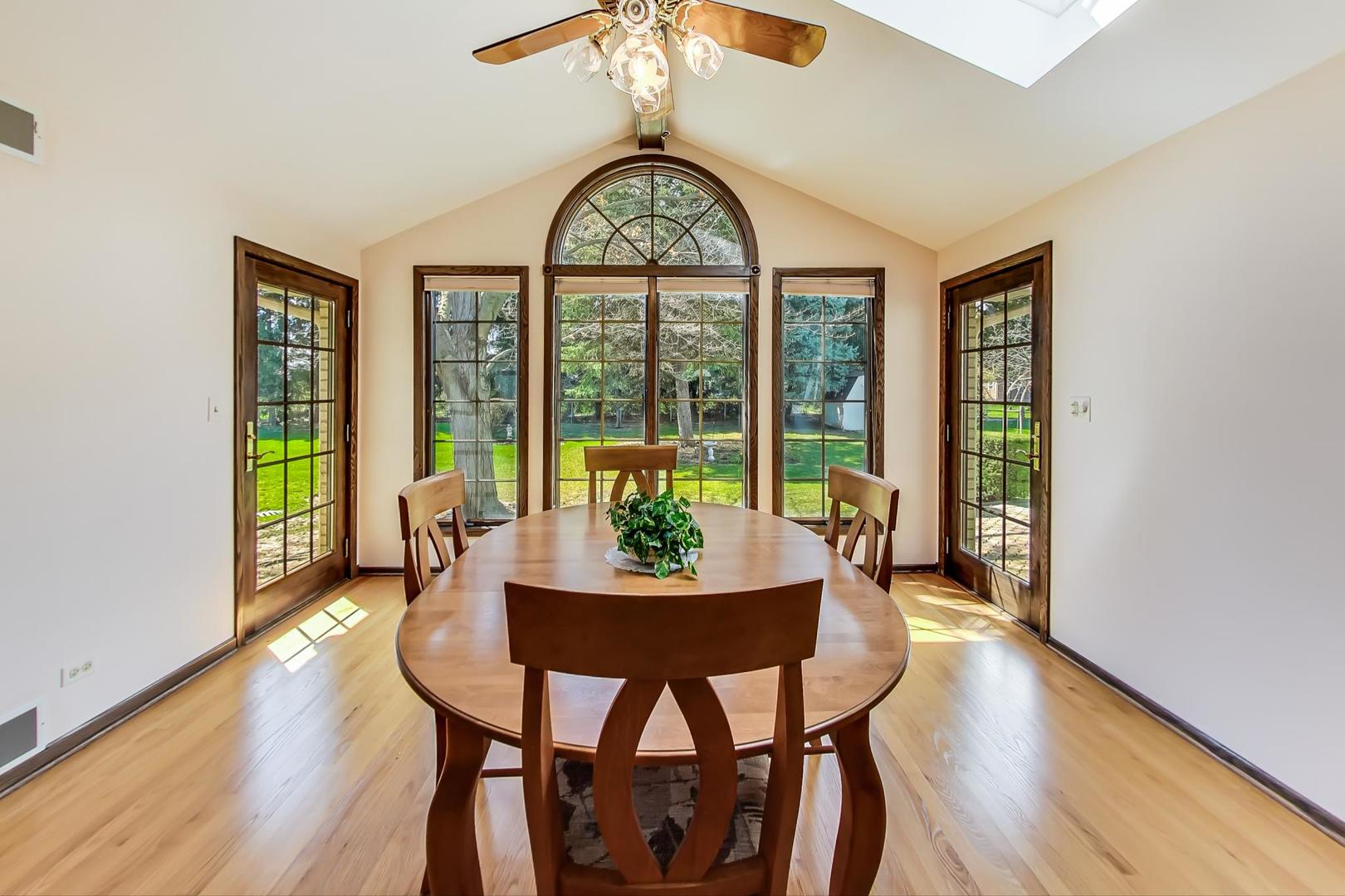 306 North Marcella Road Mount Prospect, IL 60056 - Photo 5 of 31 a dining room with furniture a chandelier and wooden floor