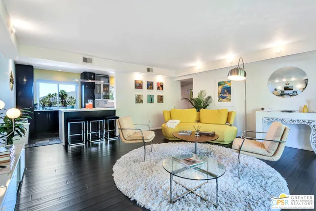 a living room with furniture dining table and a large window