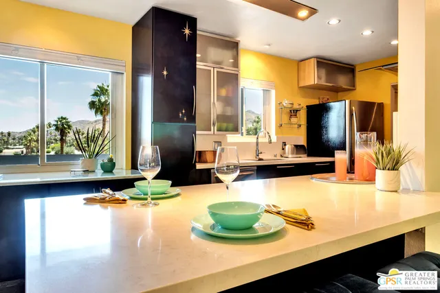 a kitchen with a sink appliances and a counter top space