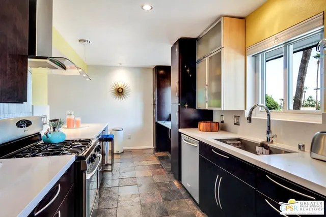 a kitchen with a sink stove and cabinets