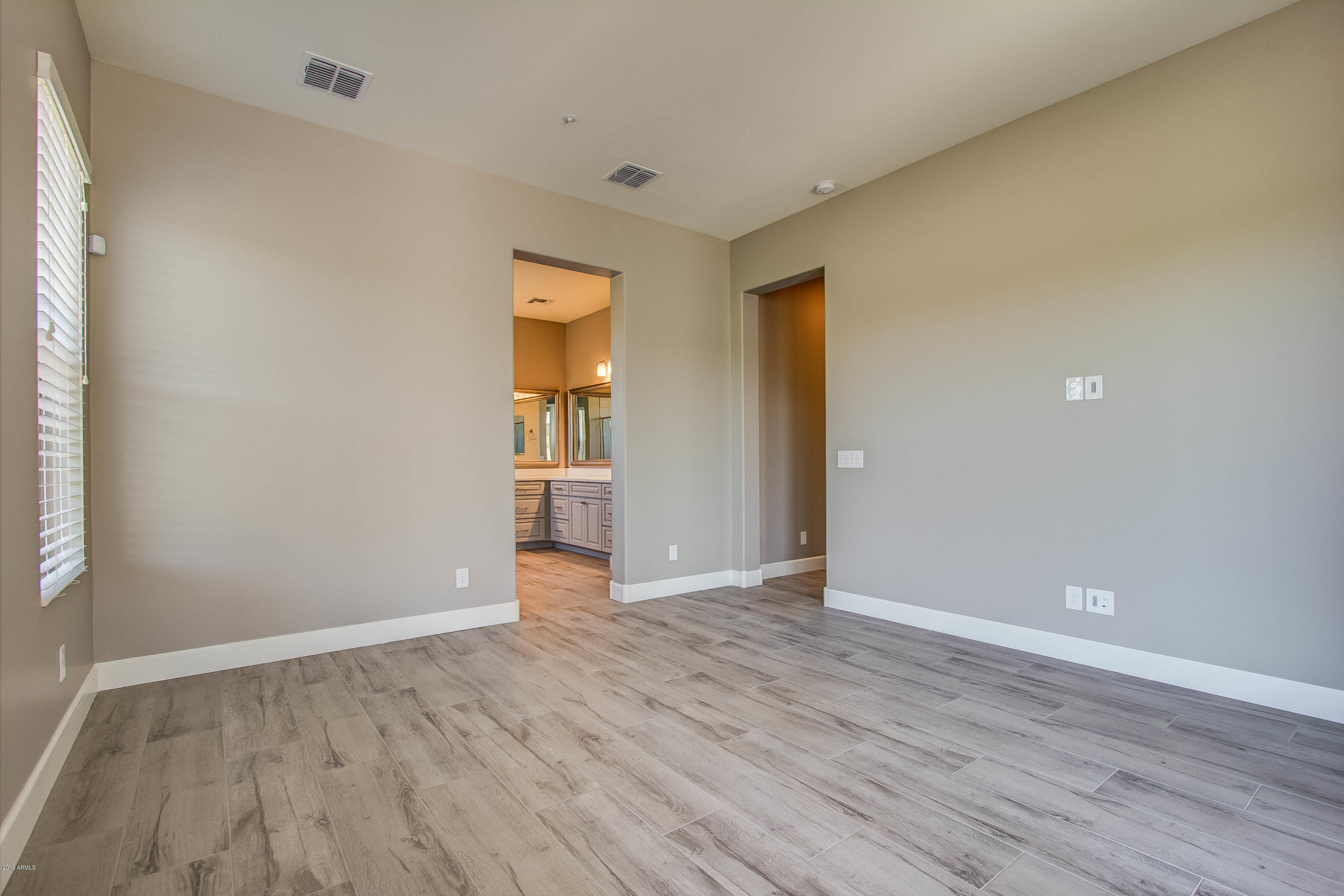 17741 East Woolsey Way Rio Verde, AZ 85263 - Photo 7 of 38 a view of an empty room with wooden floor and closet