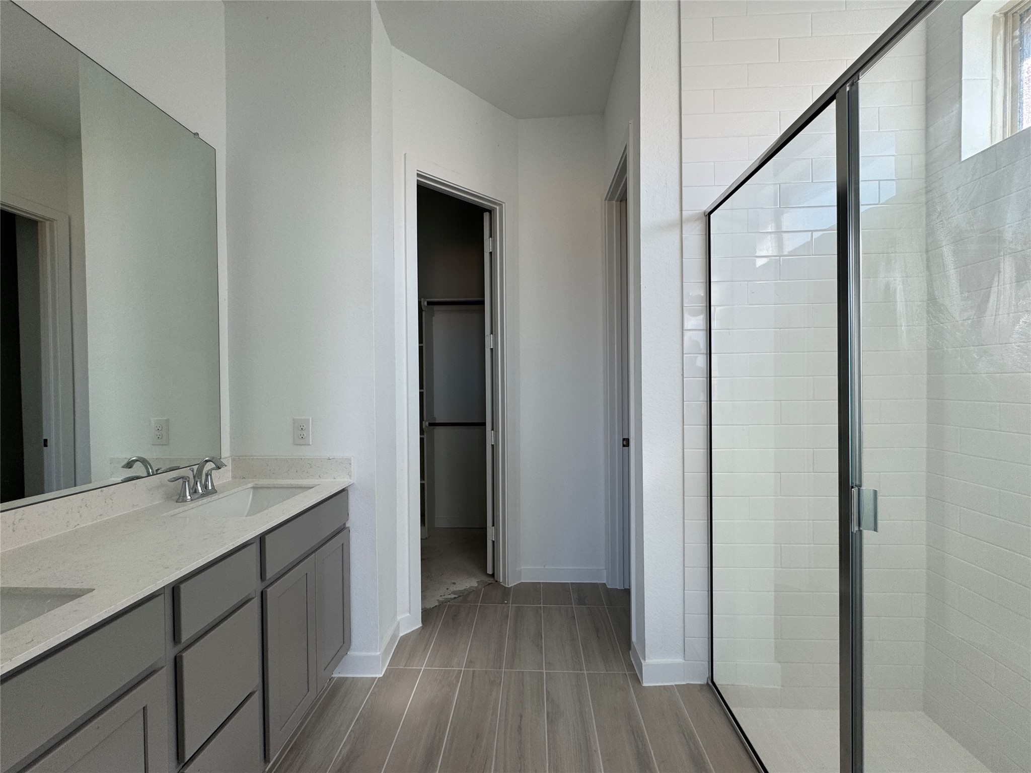 31154 Riley Hts Drive Fulshear, TX 77441 - Photo 7 of 8 a bathroom with a double vanity sink and mirror