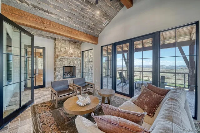 a living room with furniture and floor to ceiling windows