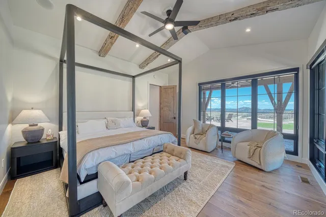 a bedroom with bed and wooden floor