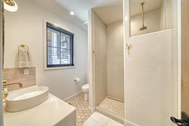a bathroom with a sink toilet and shower