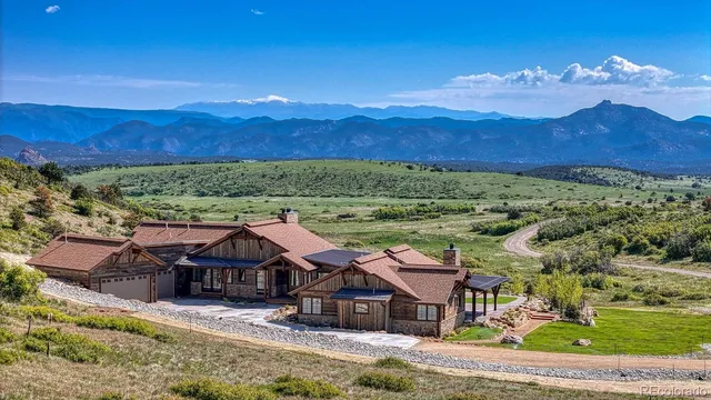 an aerial view of a house with mountain view