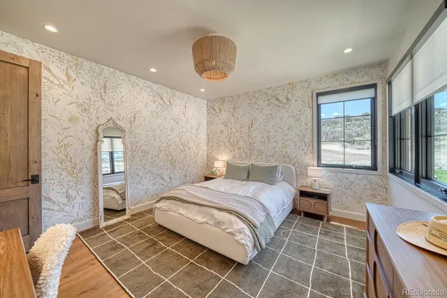 a bedroom with a large bed and a window