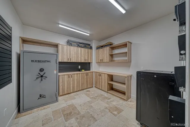 a kitchen with a refrigerator and a stove top oven