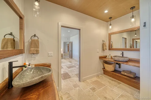 a bathroom with a granite countertop sink a toilet and mirror