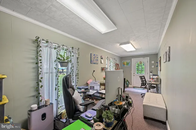 a dining room with furniture a rug and a large window
