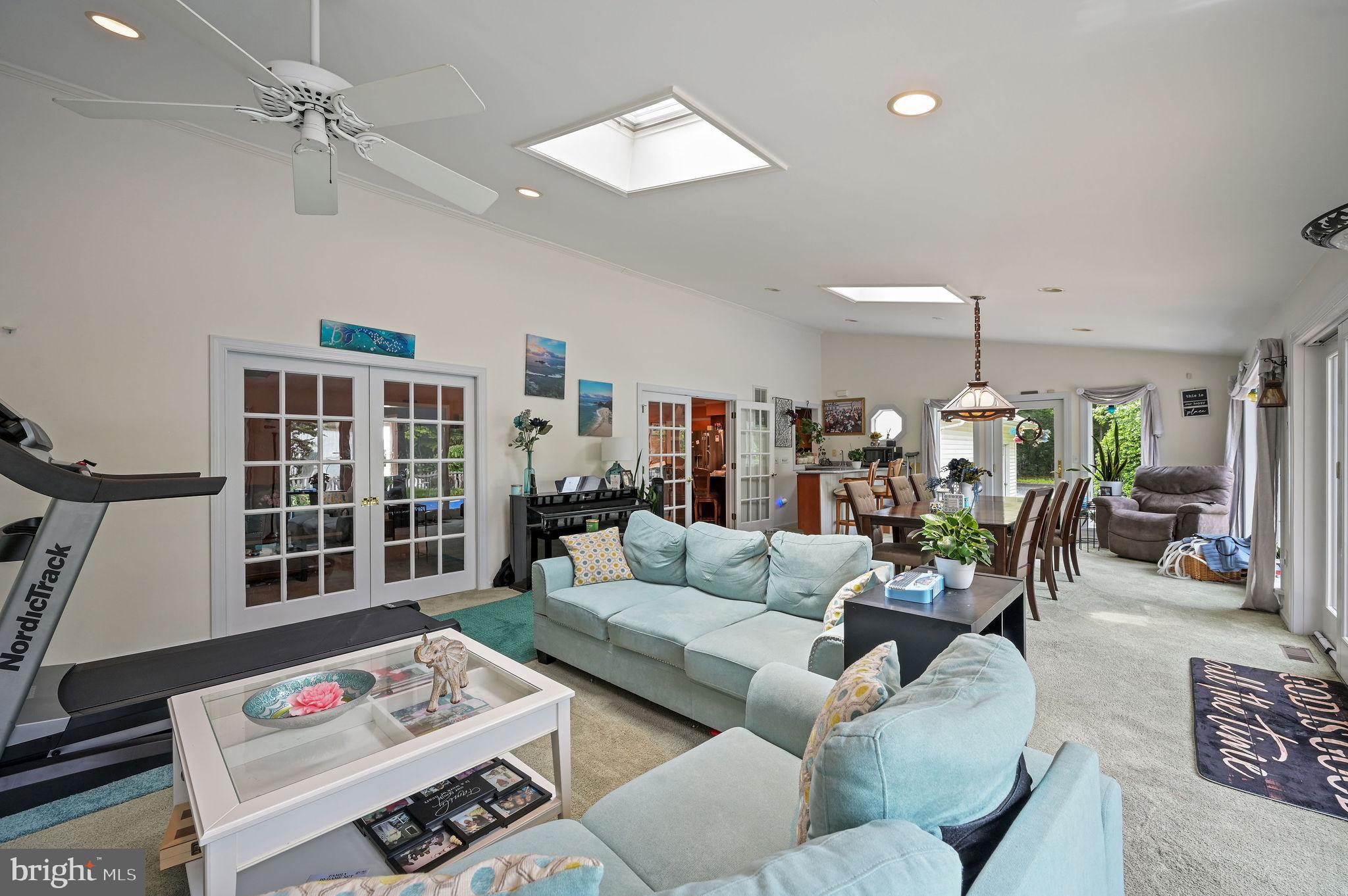 11142 Log Cabin Road Denton, MD 21629 - Photo 18 of 55 a living room with furniture a rug and a chandelier