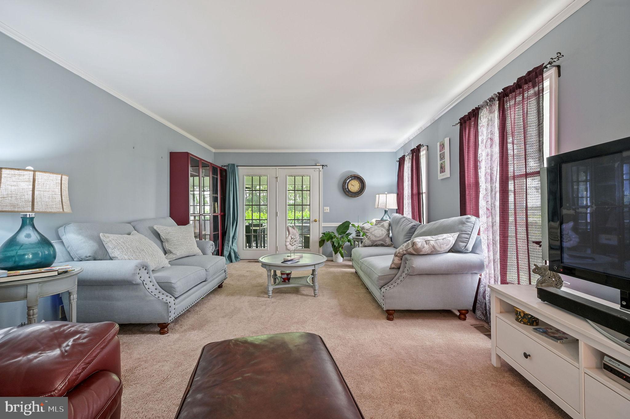 11142 Log Cabin Road Denton, MD 21629 - Photo 21 of 55 a living room with furniture a flat screen tv and a fireplace