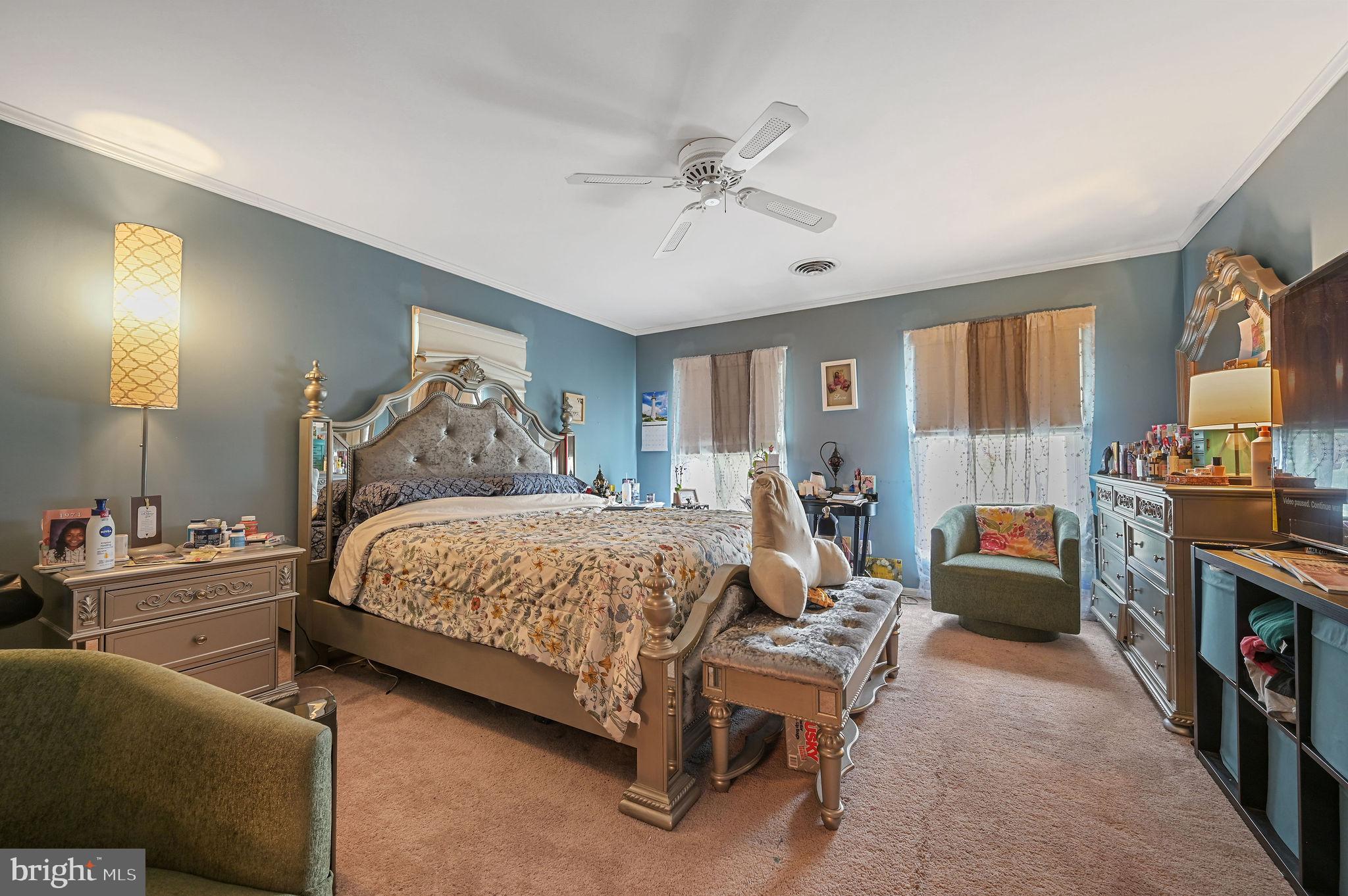 11142 Log Cabin Road Denton, MD 21629 - Photo 29 of 55 a bedroom with a bed and a chandelier