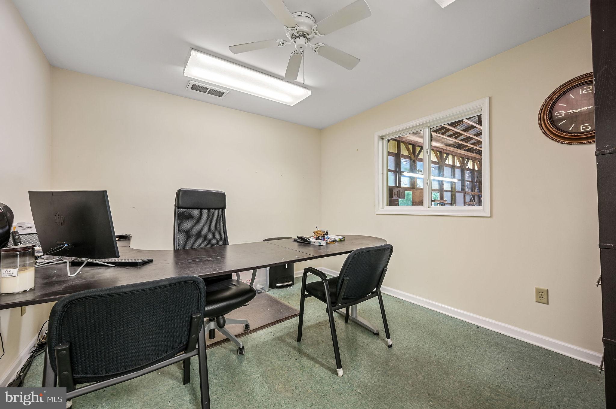 11142 Log Cabin Road Denton, MD 21629 - Photo 41 of 55 a view of a workspace with furniture and a window