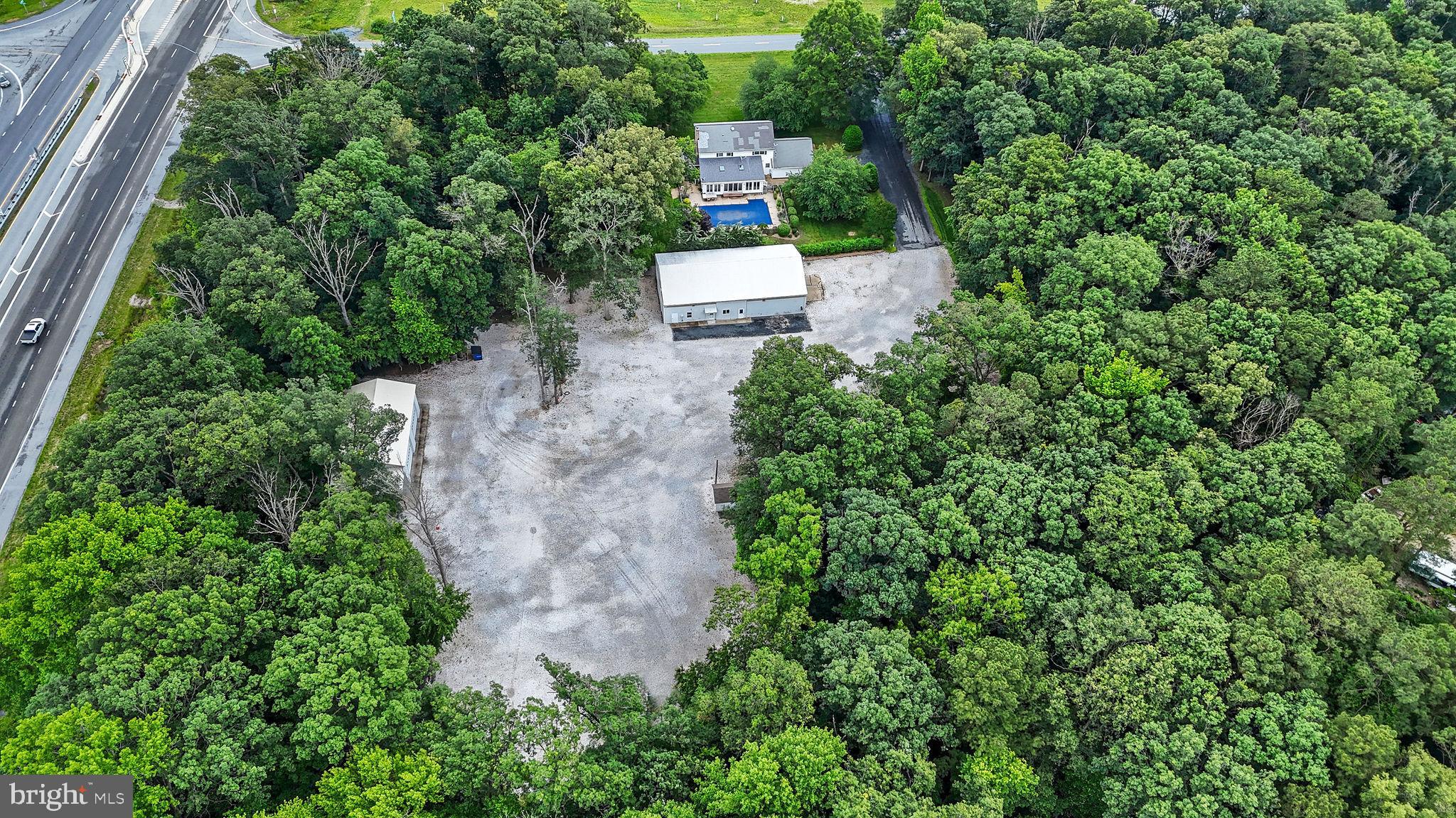 11142 Log Cabin Road Denton, MD 21629 - Photo 54 of 55 an aerial view of a house with a yard and large trees