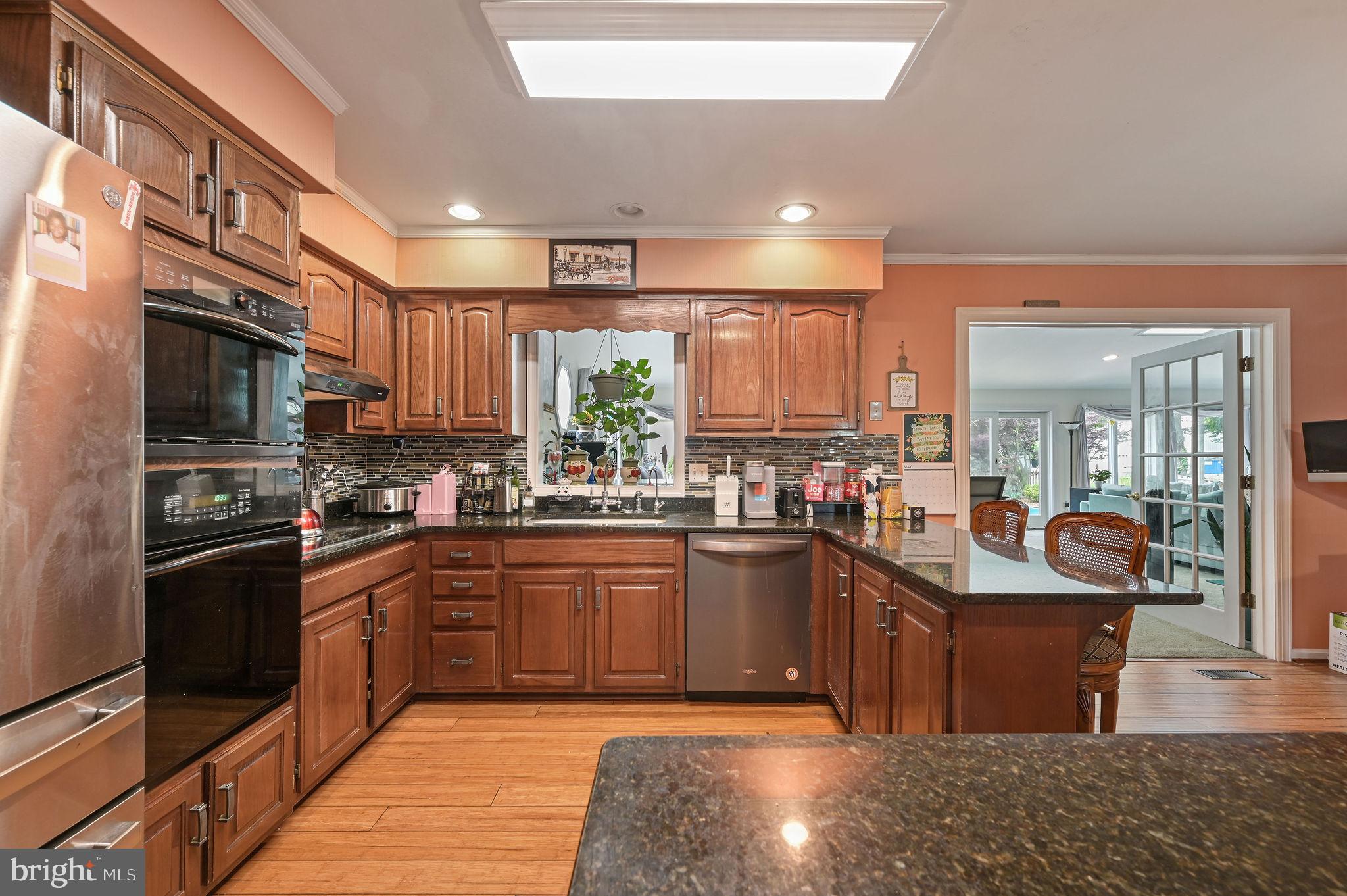 11142 Log Cabin Road Denton, MD 21629 - Photo 7 of 55 a kitchen with stainless steel appliances granite countertop a sink stove and refrigerator