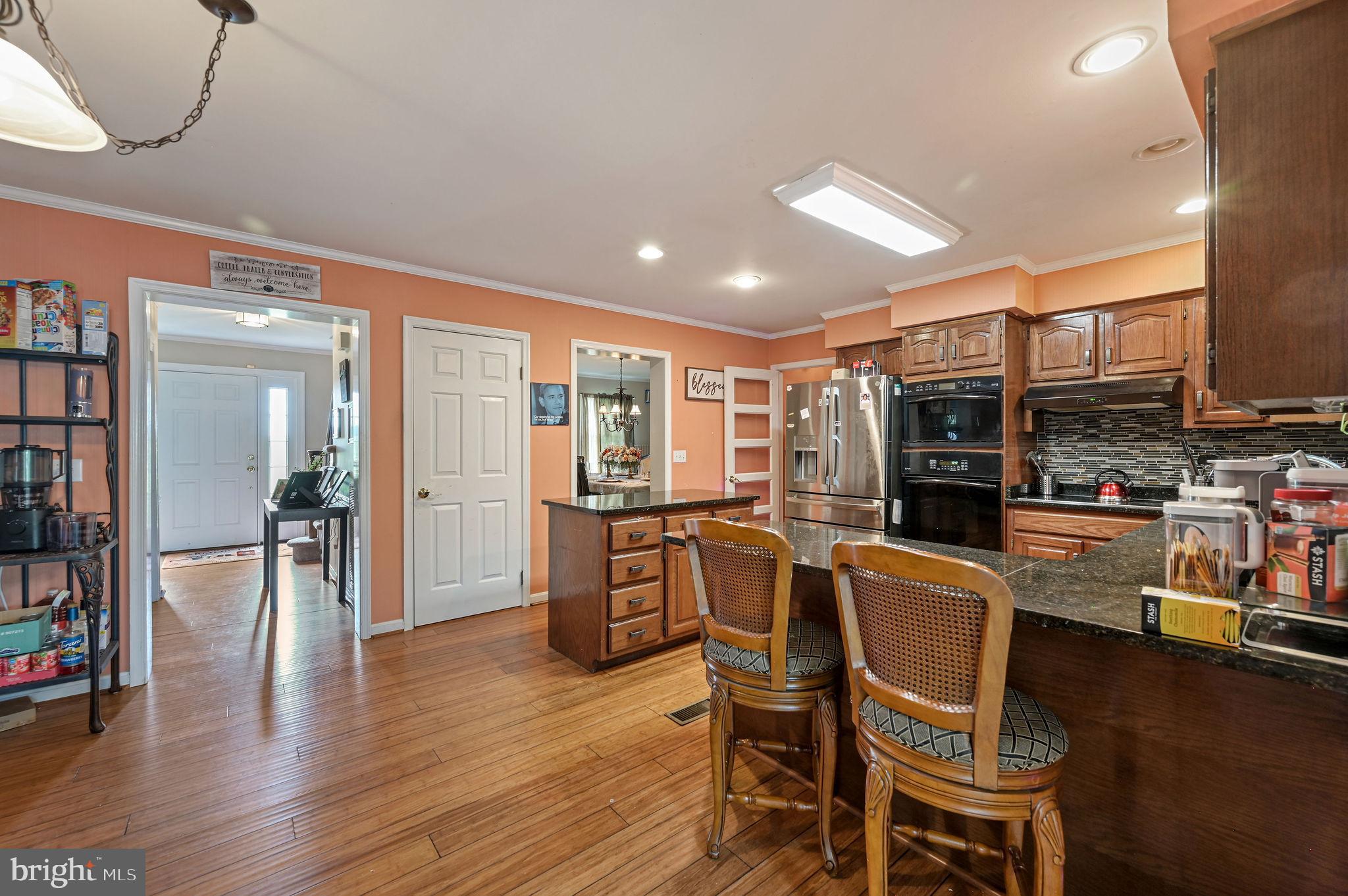 11142 Log Cabin Road Denton, MD 21629 - Photo 9 of 55 a dining room with stainless steel appliances kitchen island granite countertop a dining table chairs and view living room