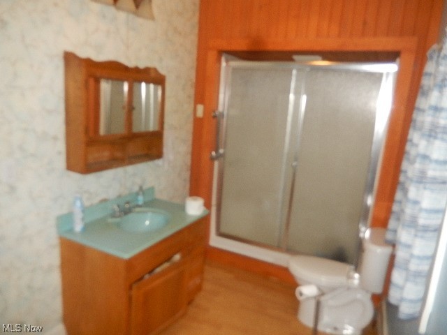 1302 Duncan Street Southwest Massillon, OH 44647 - Photo 10 of 22 Bathroom with hardwood flooring, an enclosed shower, toilet, and oversized vanity