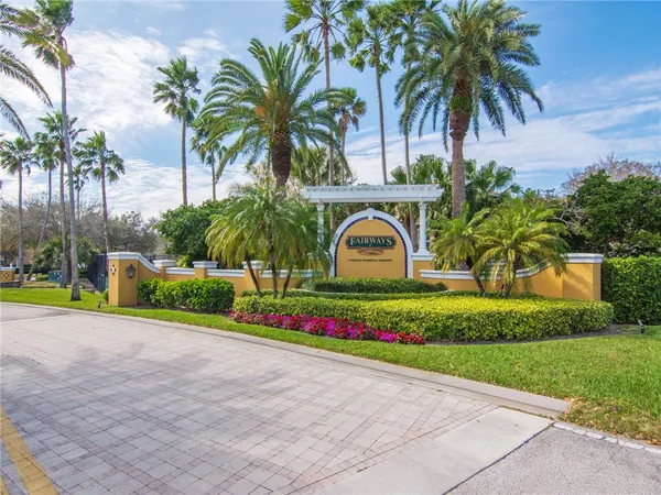 a view of garden with palm trees