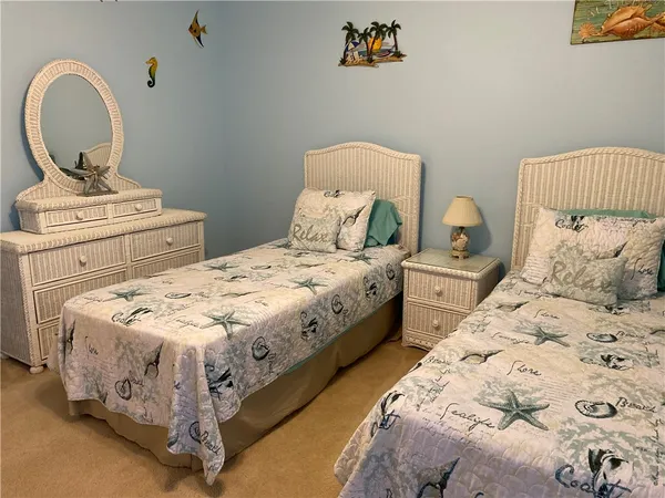 a bedroom with a bed and a potted plant
