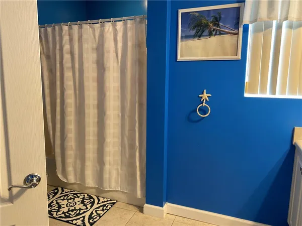 a view of bedroom with furniture and a window