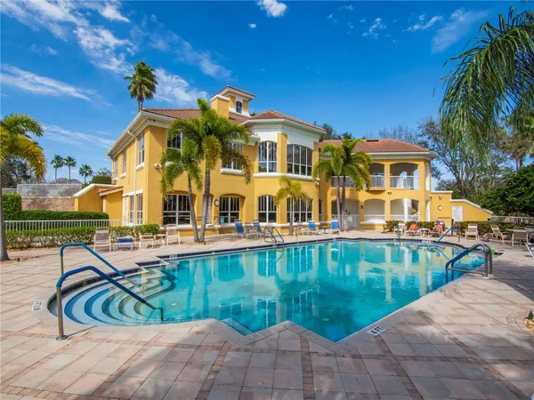 a swimming pool with outdoor seating and yard