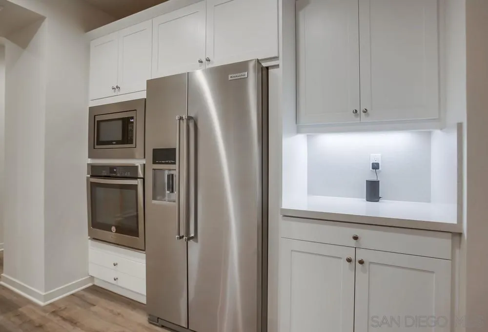 31534 Calle De Las Rosas Bonsall, CA 92003 - Photo 12 of 27 a kitchen with stainless steel appliances a refrigerator and cabinets