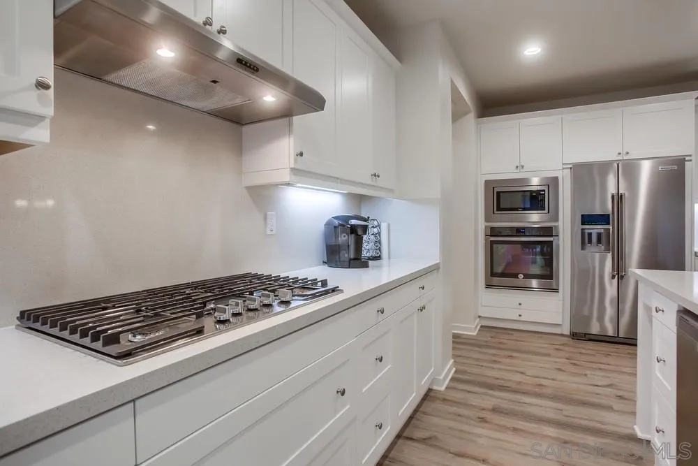 31534 Calle De Las Rosas Bonsall, CA 92003 - Photo 13 of 27 a kitchen with stainless steel appliances a refrigerator and a stove top oven