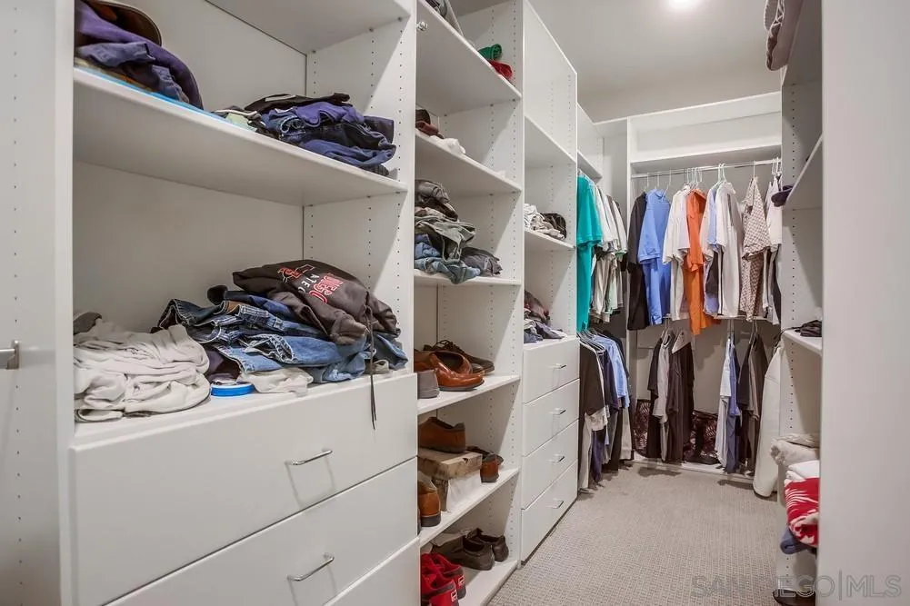 31534 Calle De Las Rosas Bonsall, CA 92003 - Photo 19 of 27 a view of walk in closet with clothes and shoes