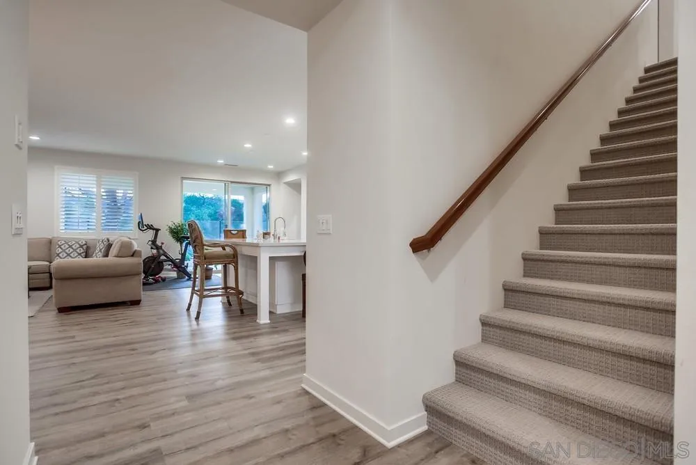 31534 Calle De Las Rosas Bonsall, CA 92003 - Photo 21 of 27 a living room with furniture and a dining table with wooden floor