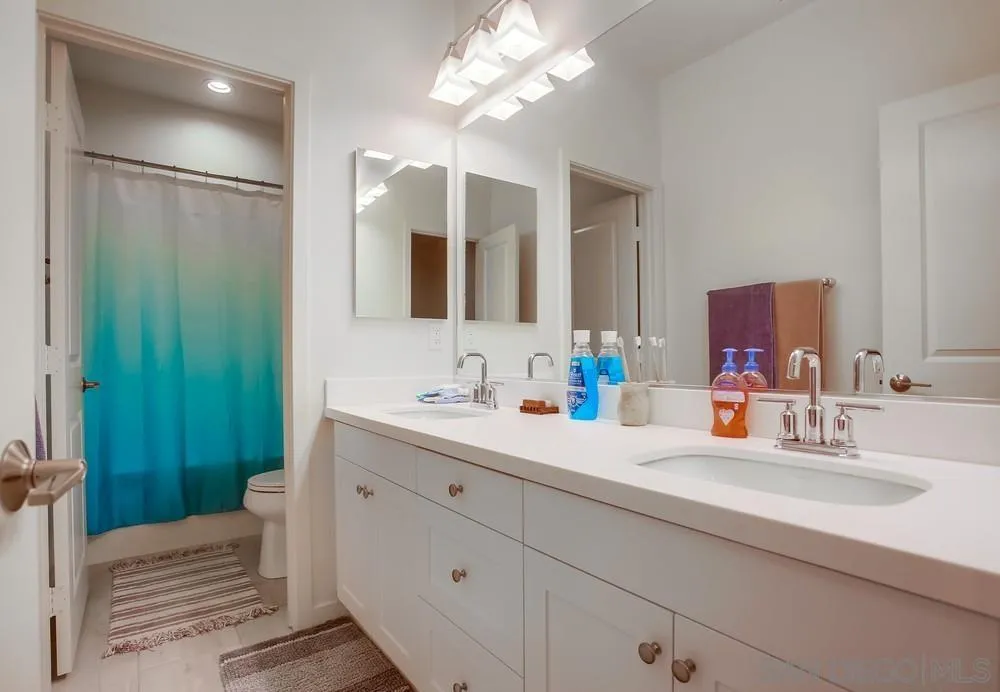 31534 Calle De Las Rosas Bonsall, CA 92003 - Photo 26 of 27 a bathroom with a double vanity sink mirror and shower