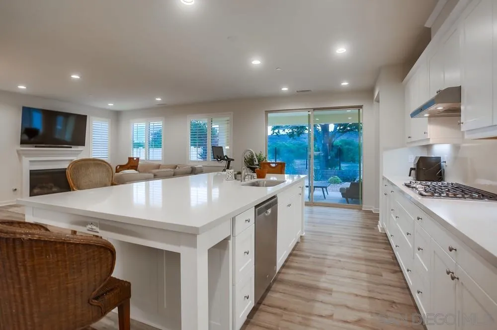 31534 Calle De Las Rosas Bonsall, CA 92003 - Photo 3 of 27 a kitchen with counter top space a sink a stove and a refrigerator