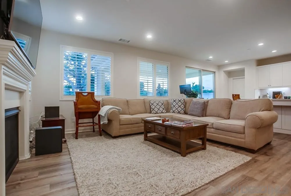 31534 Calle De Las Rosas Bonsall, CA 92003 - Photo 7 of 27 a living room with furniture a large window and a fireplace