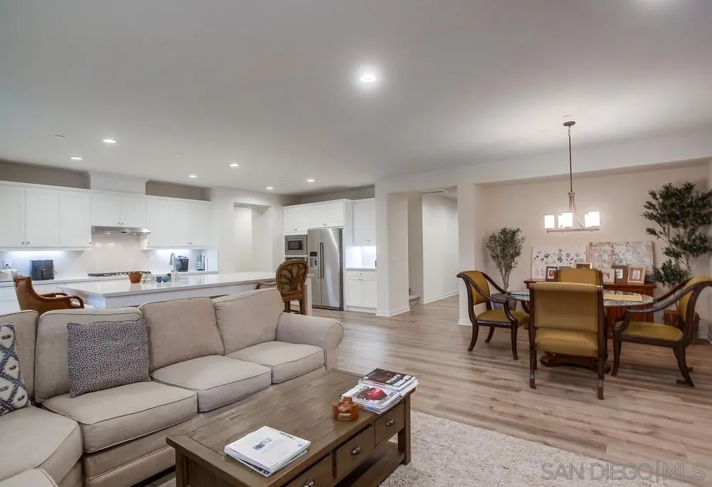 31534 Calle De Las Rosas Bonsall, CA 92003 - Photo 10 of 27 a living room with furniture a dining table and a fireplace