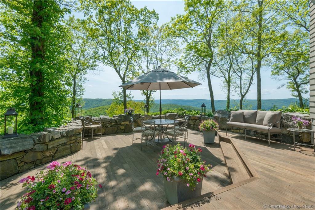 33 Nodine Pasture Road Kent, CT 06757 - Photo 29 of 40 a view of a patio with couches table and chairs potted plants and large tree